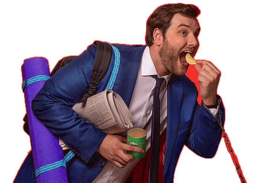 Man eating a Pringles crisp and carrying luggage